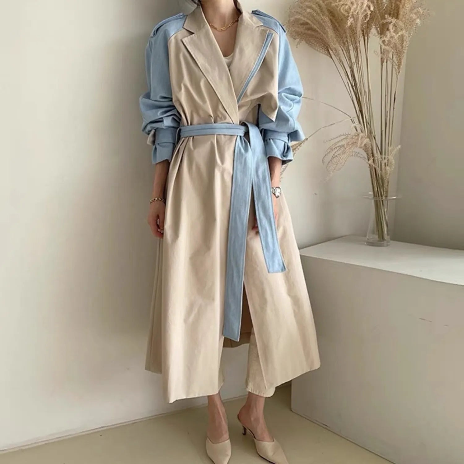 Model wearing the Baltere Trench Coat beige, emphasizing the elegant, cinched-waist fit.