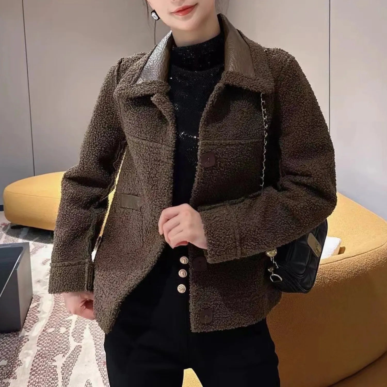 Model wearing Baltere's reversible leather jacket, showcasing its oversized collar, front buttons, and modern.