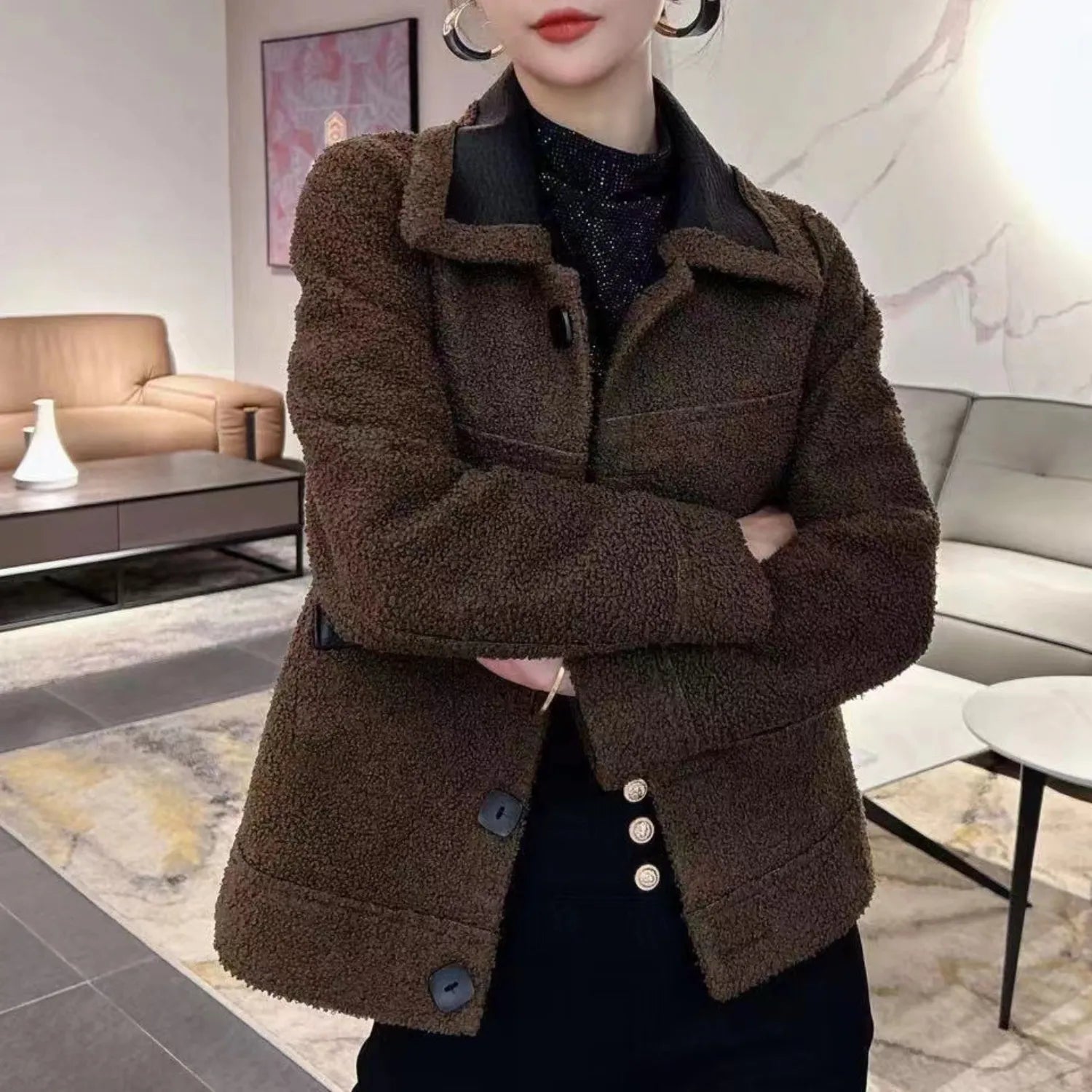 Model wearing Baltere's reversible leather jacket, showcasing its oversized collar, front buttons, and modern silhouette in brown.