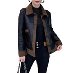 Model wearing Baltere's reversible leather jacket, showcasing its oversized collar, front buttons in black and brown.